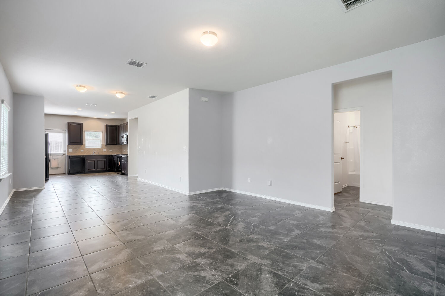 2420 Ranger Pass Seguin, TX 78155 - Photo 6 of 28 Spacious room featuring dark tile flooring and neutral-toned walls