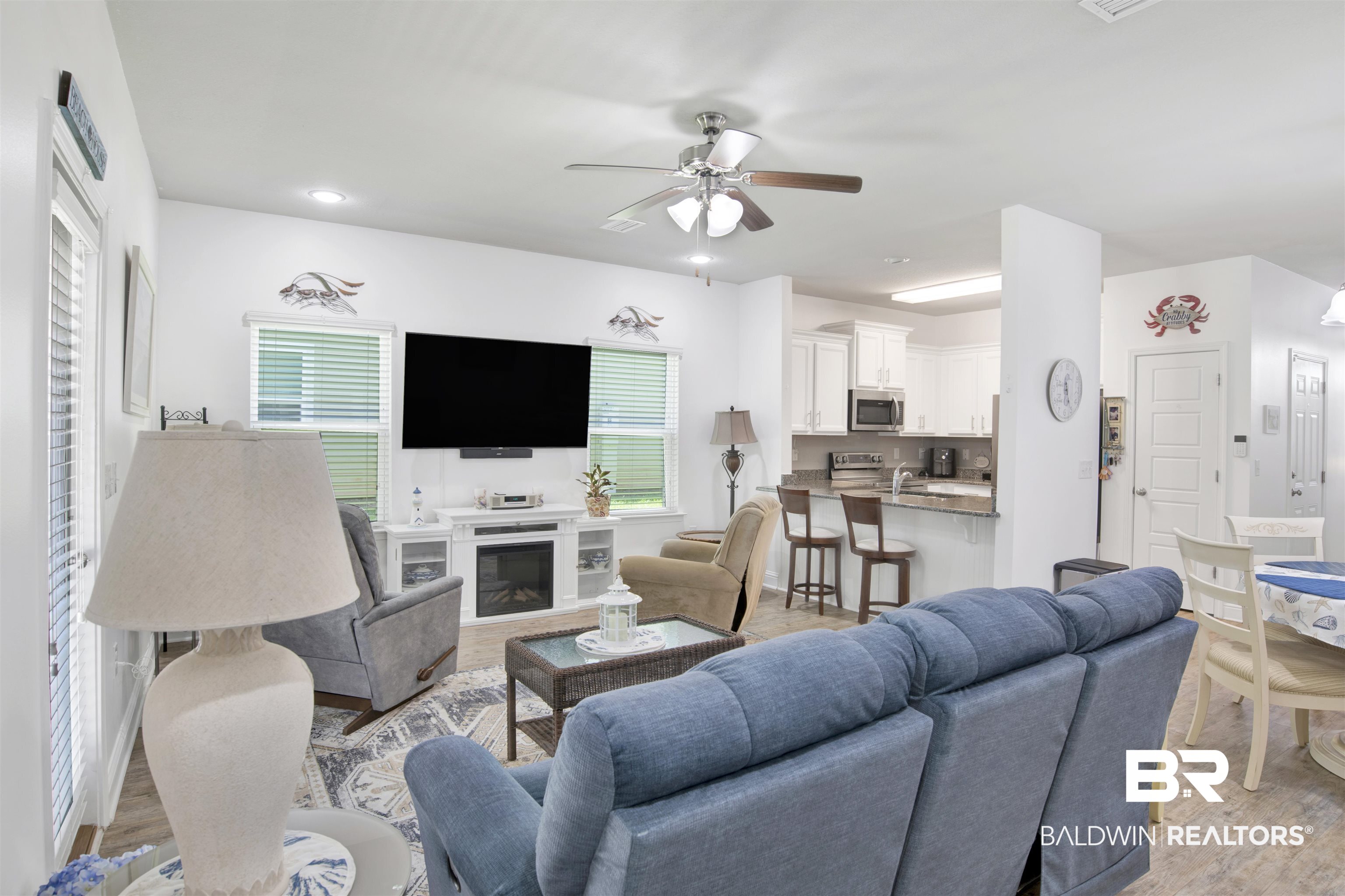 25806 Pollard Road, Unit 20 Daphne, AL 36526 - Photo 10 of 29 Living room featuring a fireplace, ceiling fan, and light wood-type flooring