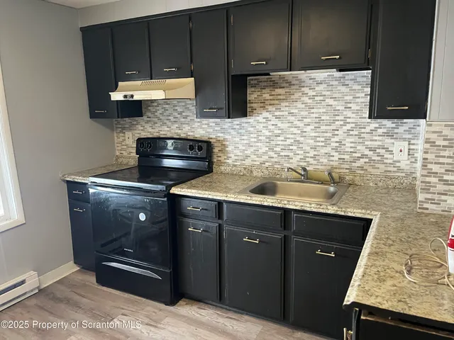 a kitchen with stainless steel appliances granite countertop a stove and a microwave oven