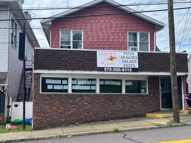 a front view of a house with yard