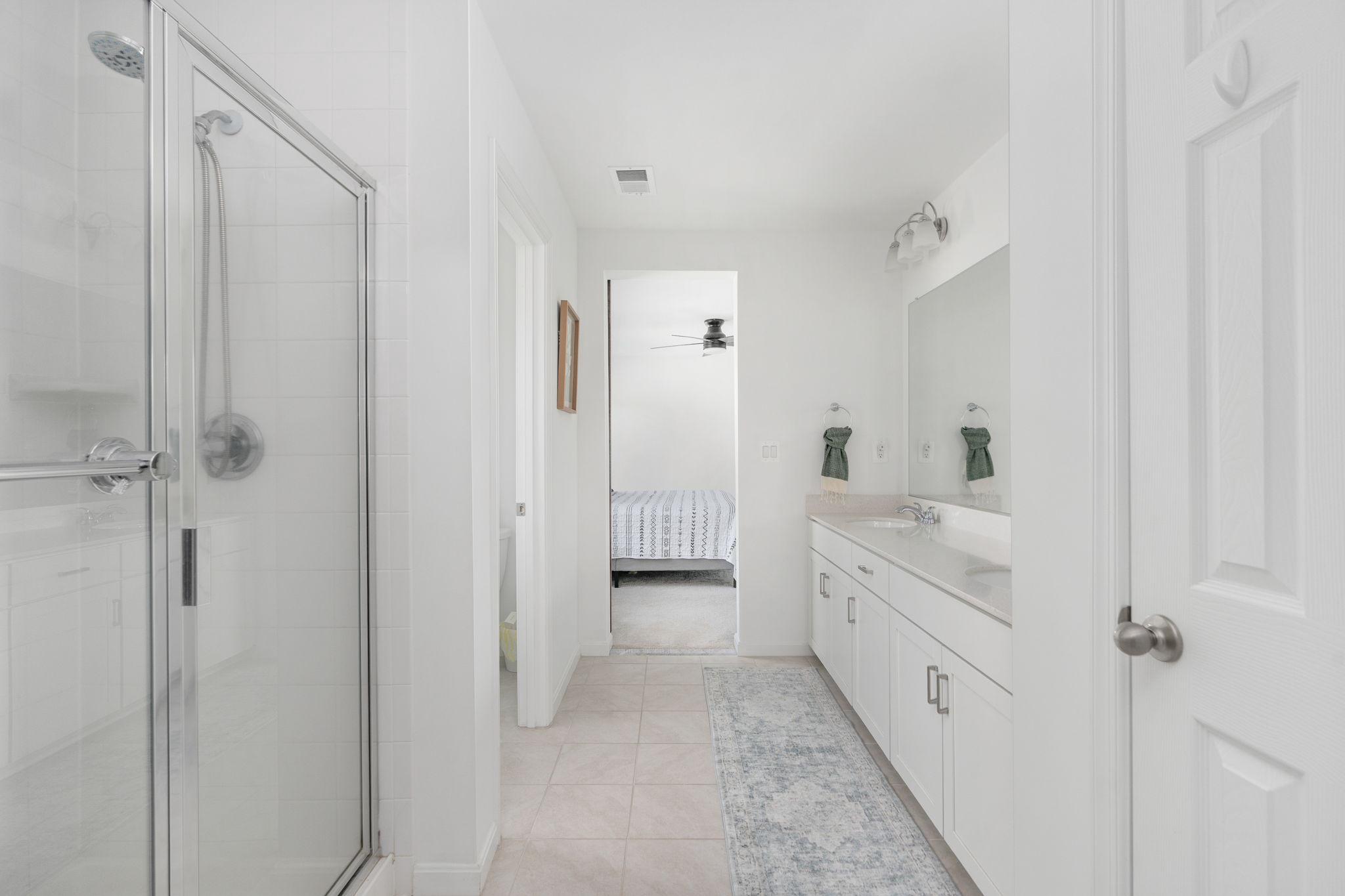 6371 Pointer Lane King George, VA 22485 - Photo 25 of 38 a bathroom with a double vanity sink and mirror