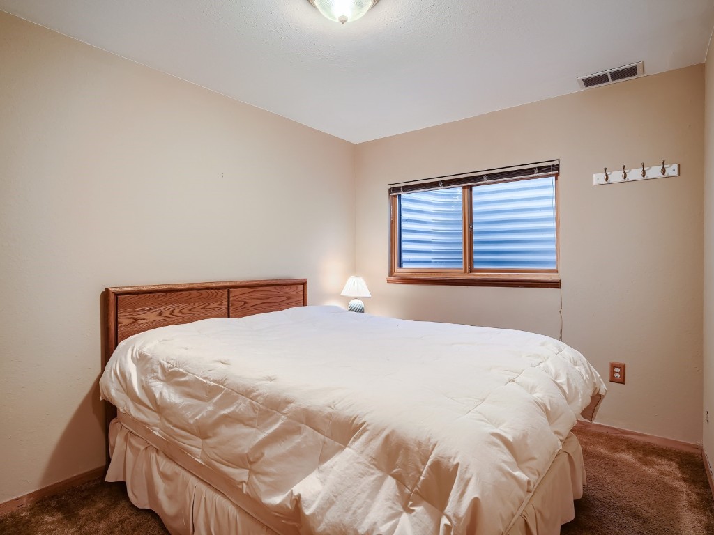 52 Club House Road, Unit 54 Breckenridge, CO 80424 - Photo 19 of 28 a bedroom with a bed and a window