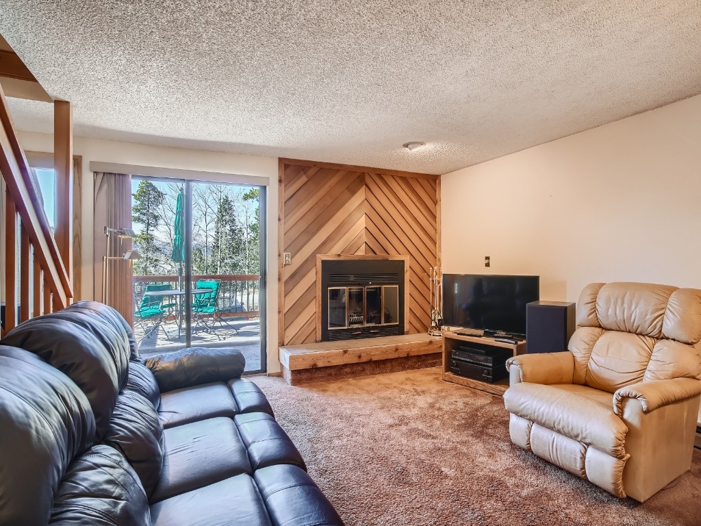 52 Club House Road, Unit 54 Breckenridge, CO 80424 - Photo 5 of 28 a living room with furniture a large window and a flat screen tv