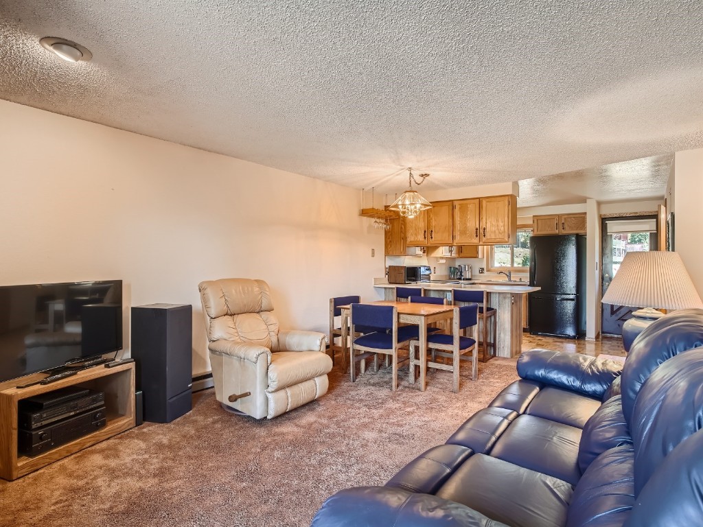 52 Club House Road, Unit 54 Breckenridge, CO 80424 - Photo 6 of 28 a living room with furniture and a flat screen tv