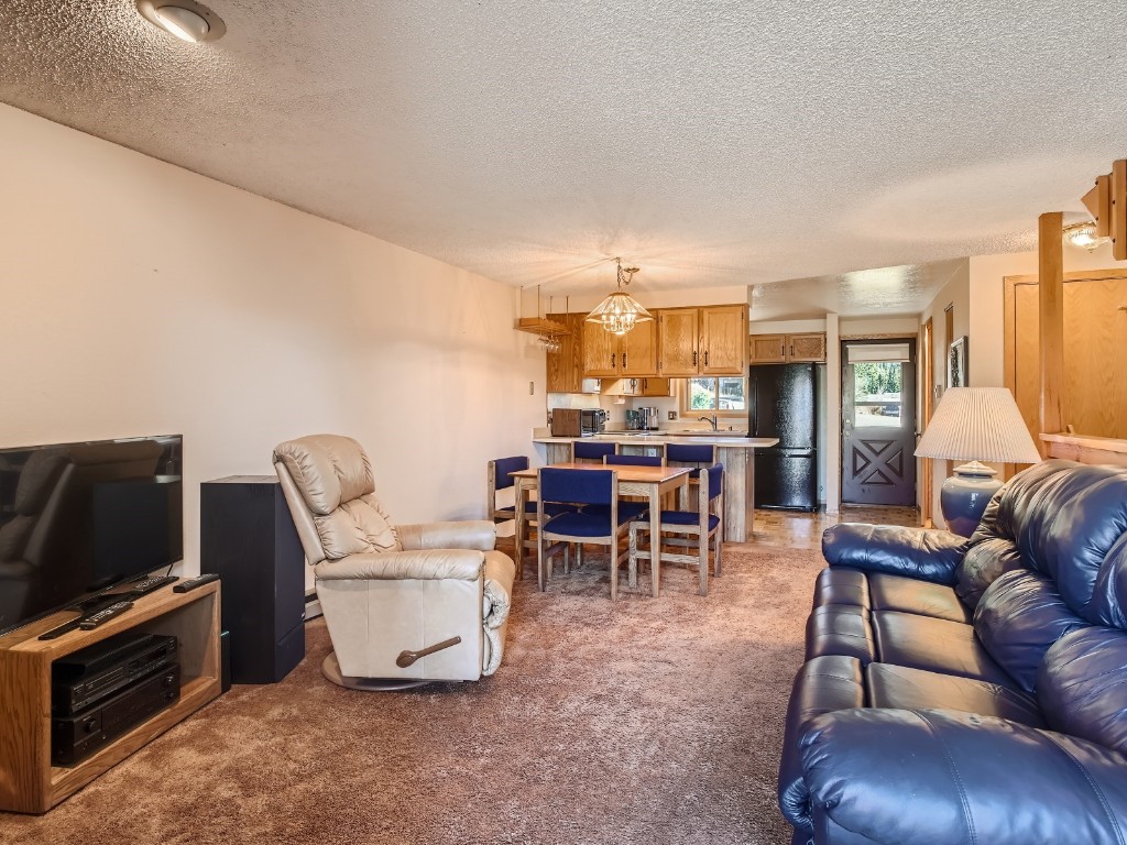 52 Club House Road, Unit 54 Breckenridge, CO 80424 - Photo 7 of 28 a living room with furniture and a dining table