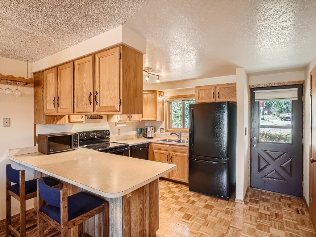 52 Club House Road, Unit 54 Breckenridge, CO 80424 - Photo 8 of 28 a kitchen with stainless steel appliances a stove a refrigerator and a refrigerator