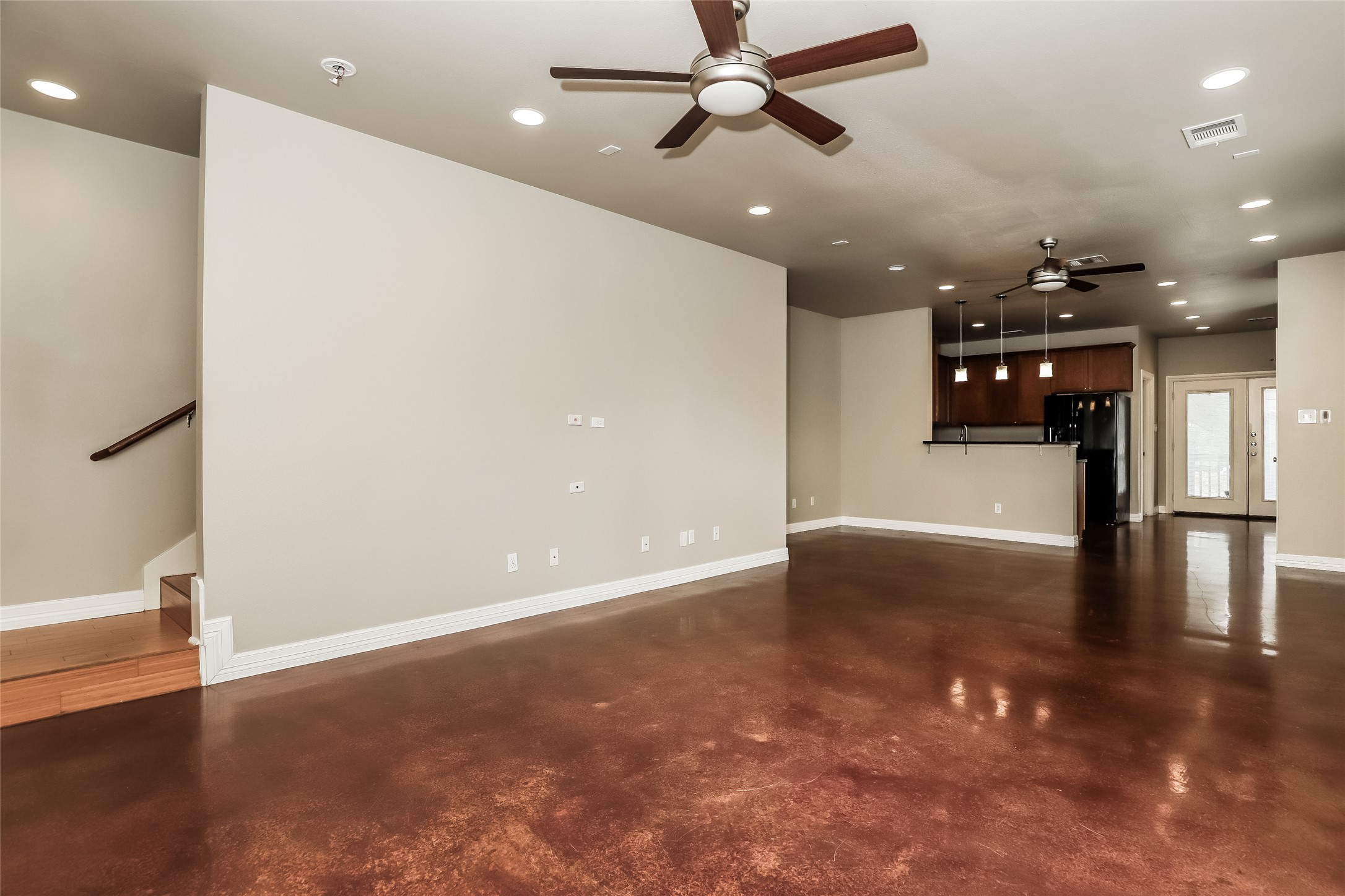 1701 Sanchez Street, Unit A Austin, TX 78702 - Photo 7 of 19 An open concept living area showcasing rich flooring and a convenient kitchen passthrough.