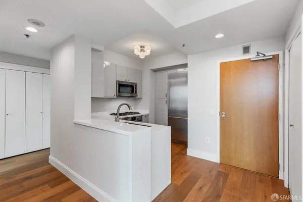 a kitchen with a refrigerator and a stove top oven