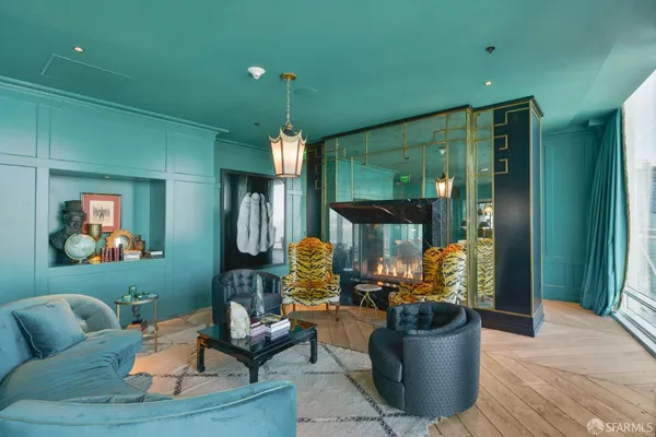 a dining room filled chandelier and kitchen view