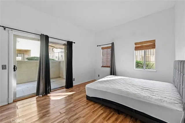 a view of a bedroom with wooden floor and bathroom