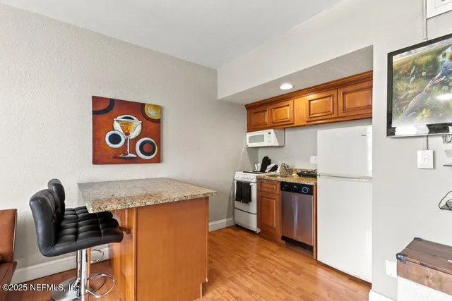 a kitchen with stainless steel appliances granite countertop a stove and a refrigerator