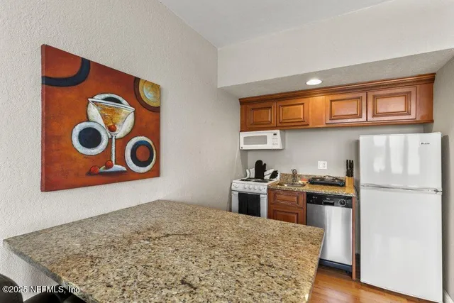 a kitchen with a stove and a refrigerator