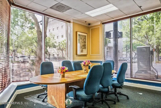 a view of a dining room with furniture window and outside view