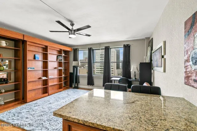 a view of a livingroom with furniture and staircase