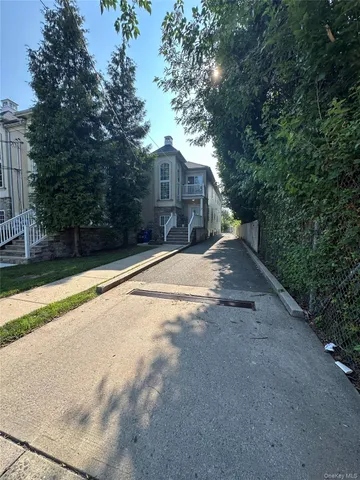 a view of a house with large trees