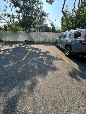 a view of a backyard and a car parked