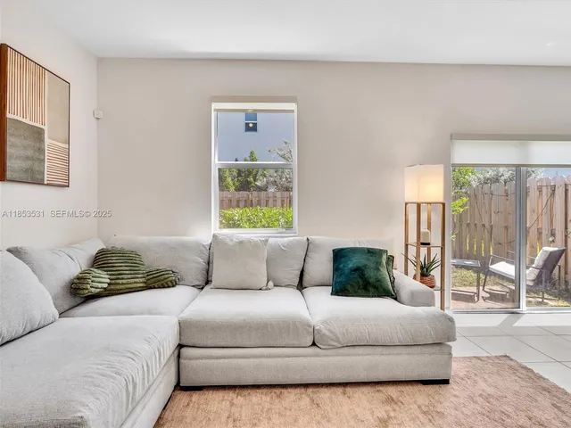 a kitchen with kitchen island cabinets and chairs in it