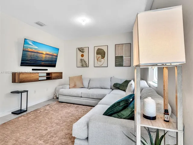 a kitchen with stainless steel appliances granite countertop a sink and a refrigerator