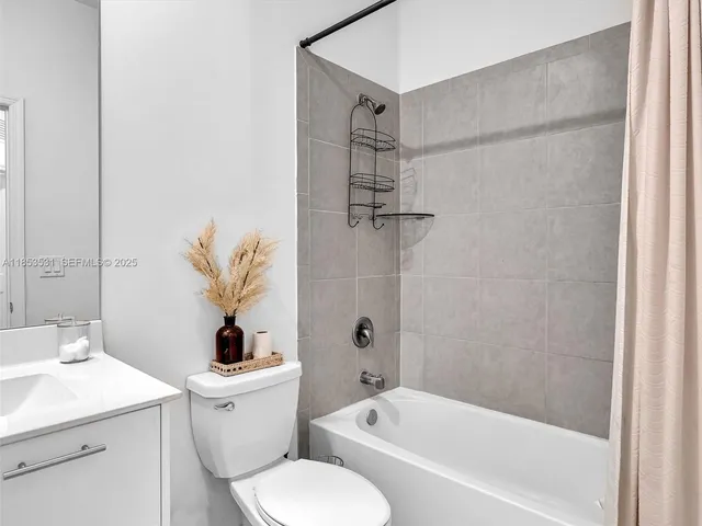 a large bed sitting in a bedroom and dresser