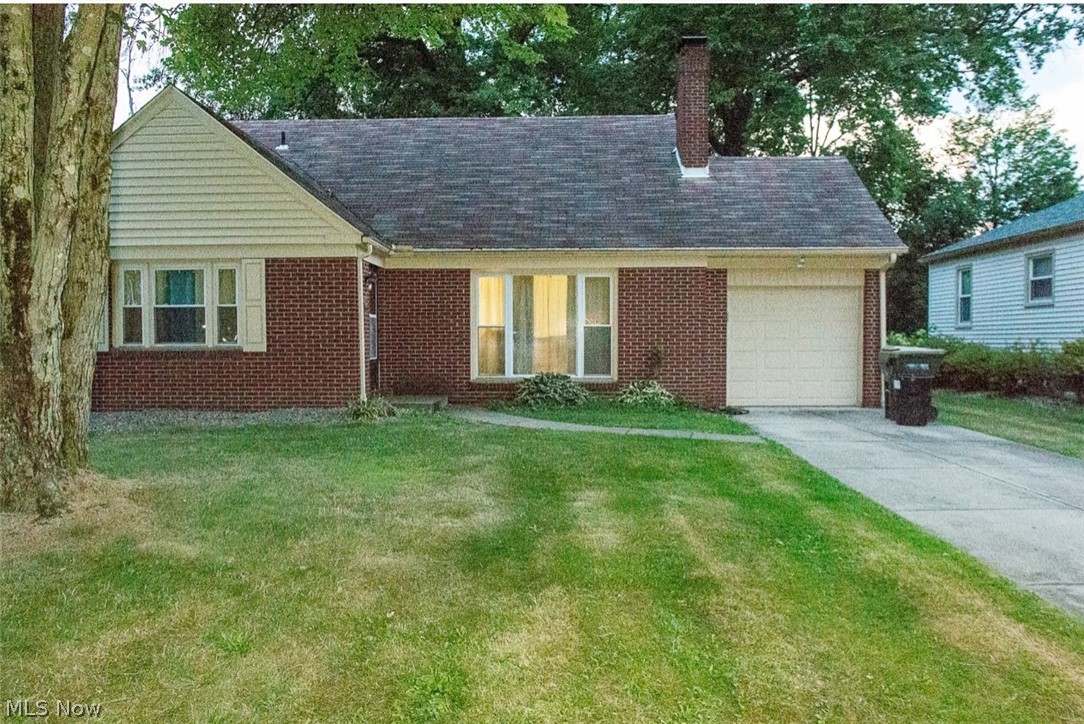 6714 Trenholm Road Youngstown, OH 44512 - Photo 1 of 22 View of front of home featuring a garage and a front yard