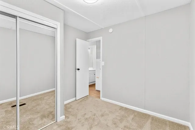 a view of an empty room with closet