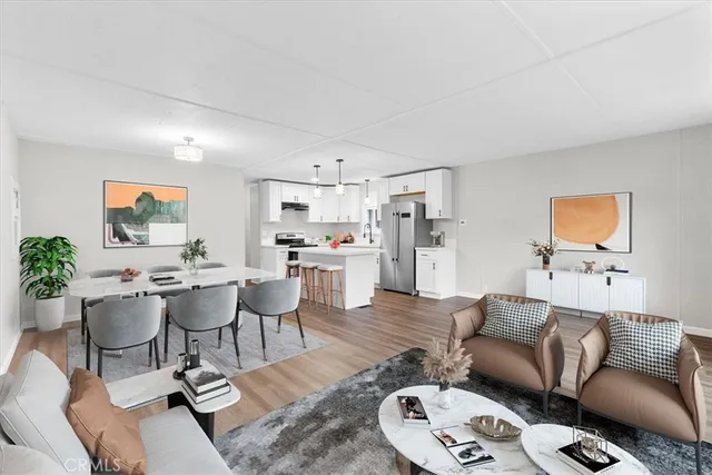 a living room with furniture kitchen view and a dining table