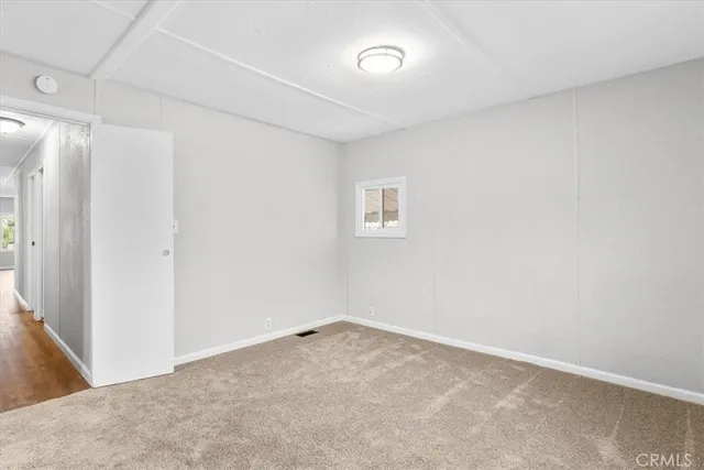 a view of an empty room with a closet