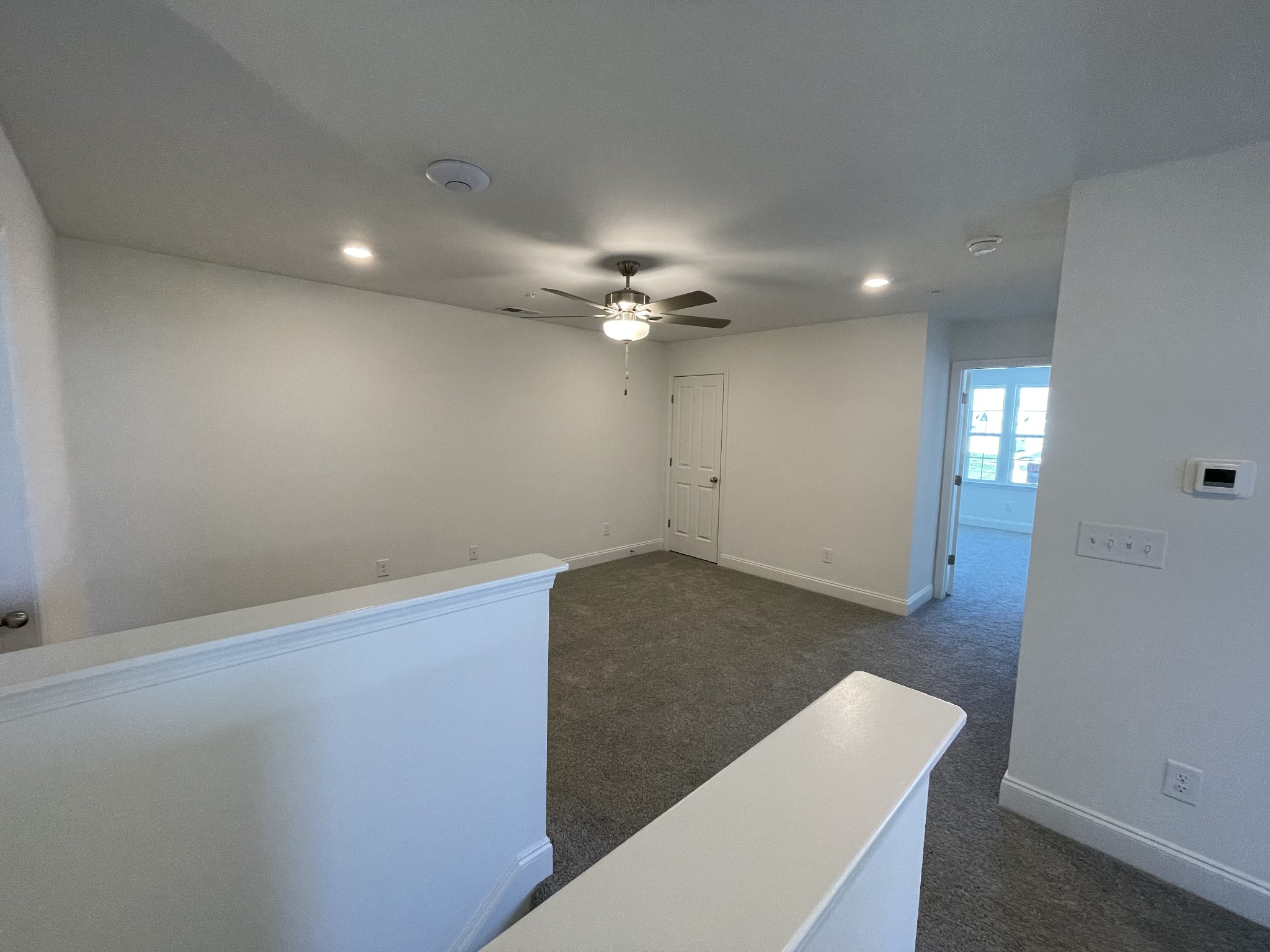 1156 June Wilde Ridge Spring Hill, TN 37174 - Photo 12 of 20 an empty room with wooden floor and chandelier fan