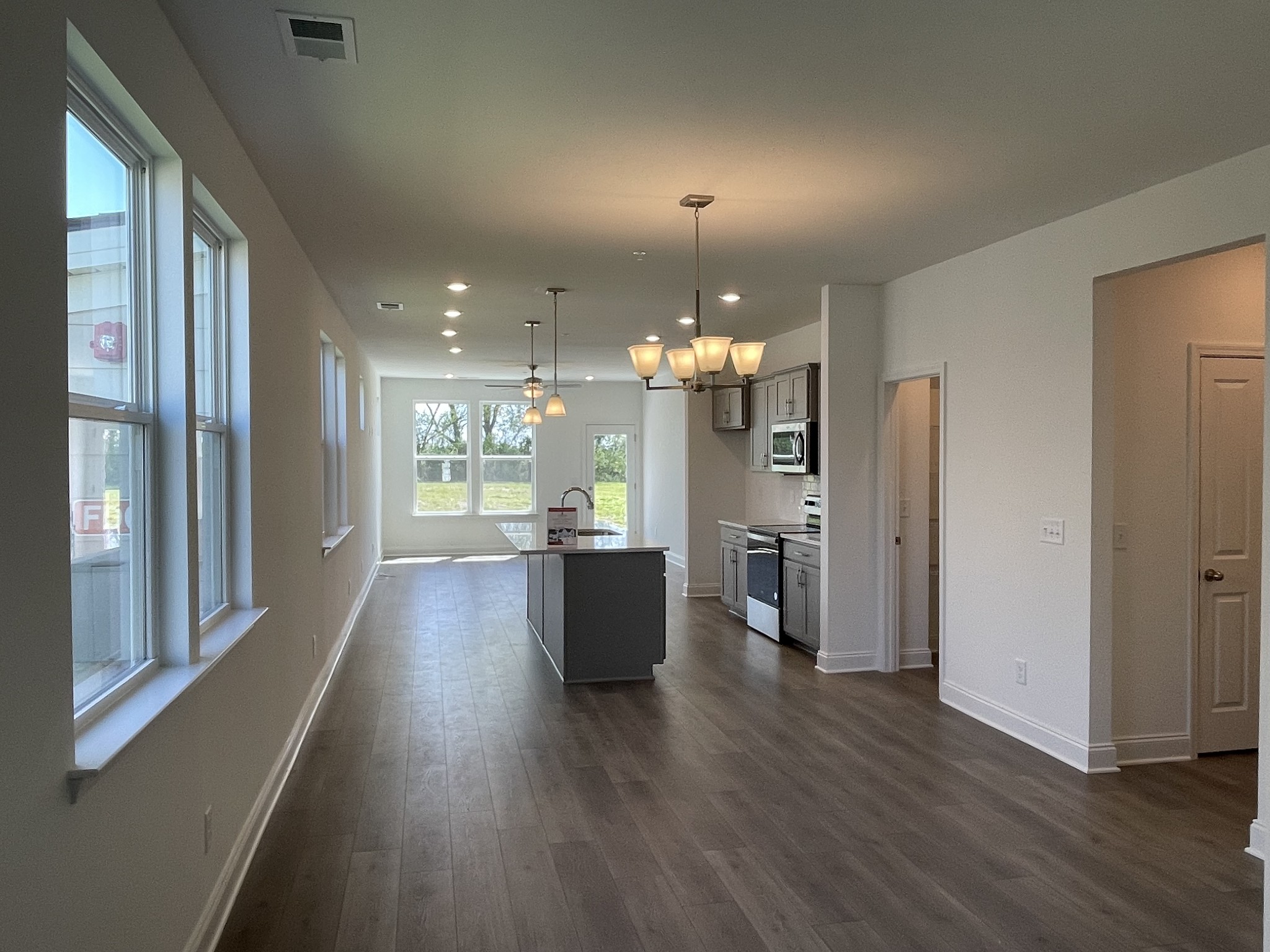 1156 June Wilde Ridge Spring Hill, TN 37174 - Photo 3 of 20 a view of a living room and kitchen with wooden floor
