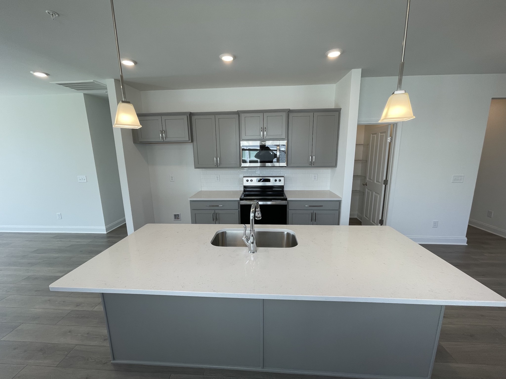 1156 June Wilde Ridge Spring Hill, TN 37174 - Photo 5 of 20 a kitchen with kitchen island white cabinets and refrigerator