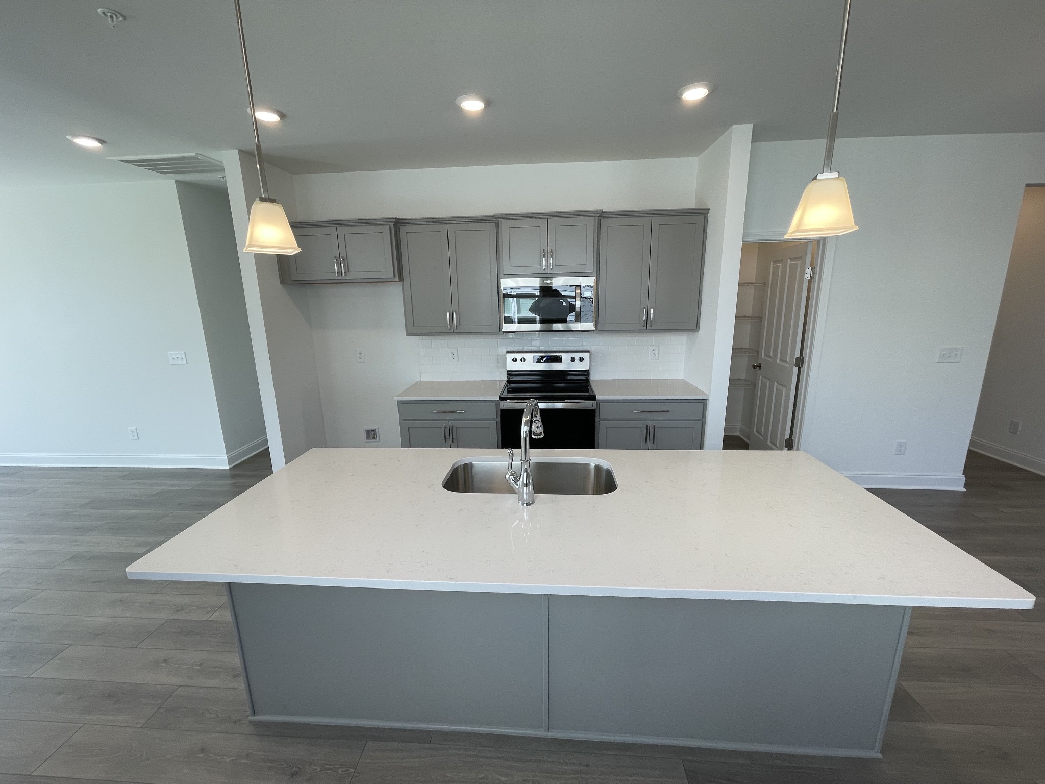 1156 June Wilde Ridge Spring Hill, TN 37174 - Photo 6 of 20 a kitchen with kitchen island a sink a stove a refrigerator and a fireplace