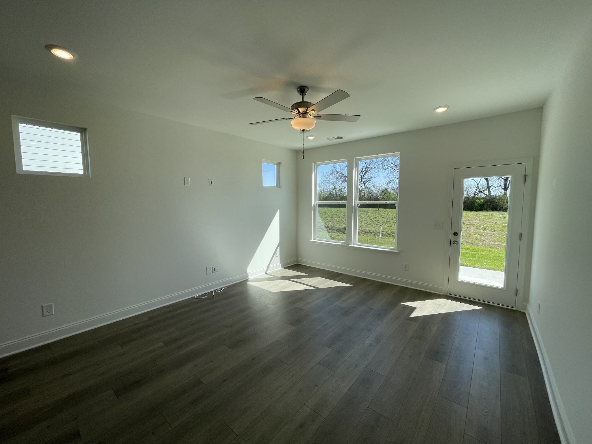 1156 June Wilde Ridge Spring Hill, TN 37174 - Photo 8 of 20 a view of an empty room with a window and wooden floor