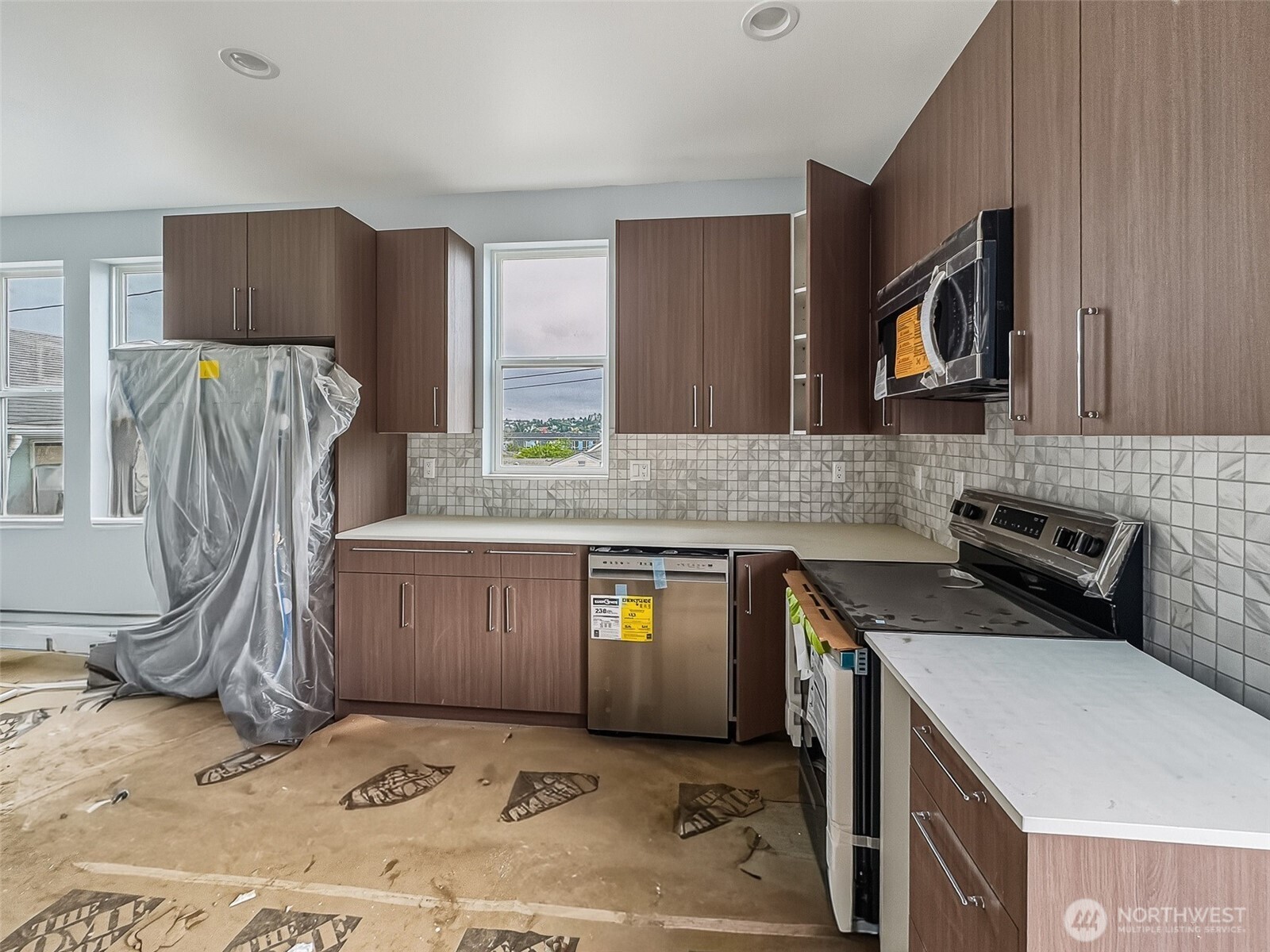 2317 22nd Avenue South Seattle, WA 98144 - Photo 13 of 29 a kitchen with stainless steel appliances granite countertop a sink stove and refrigerator