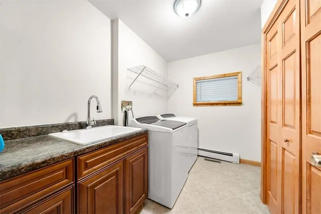 a view of a kitchen with a sink and wooden floor