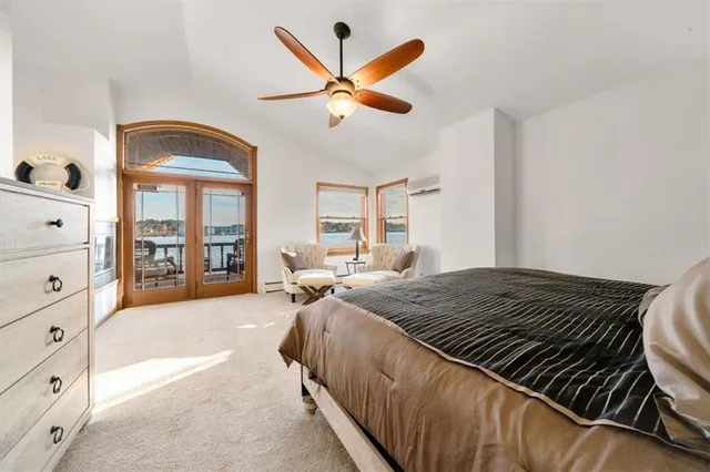 a bedroom with a large bed and a large window