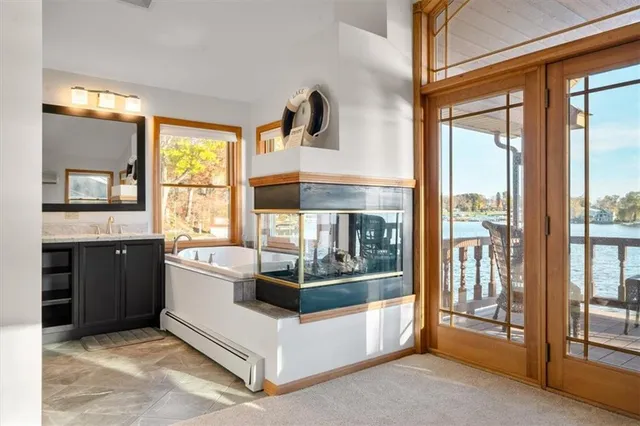 a view of en suite bathroom with a tub and window