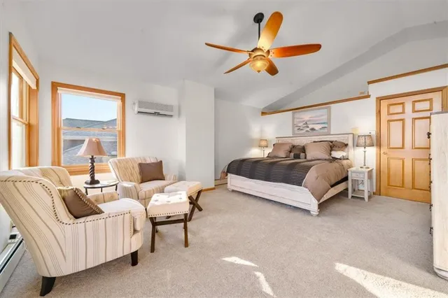 a bedroom with furniture and a large window