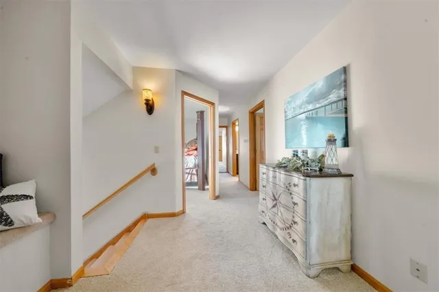 a view of hallway with livingroom and furniture