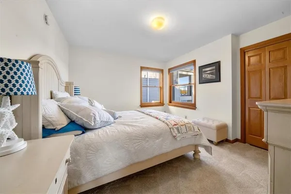 a bedroom with bed and wooden floor