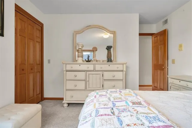 a bedroom with a bed and a dresser