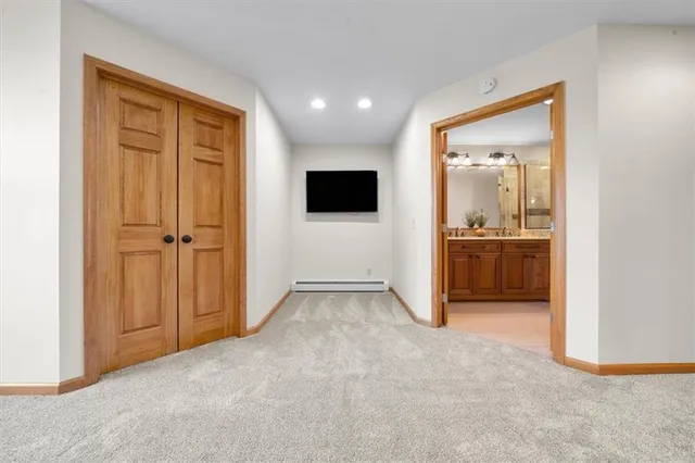 an empty room with closet and wooden door