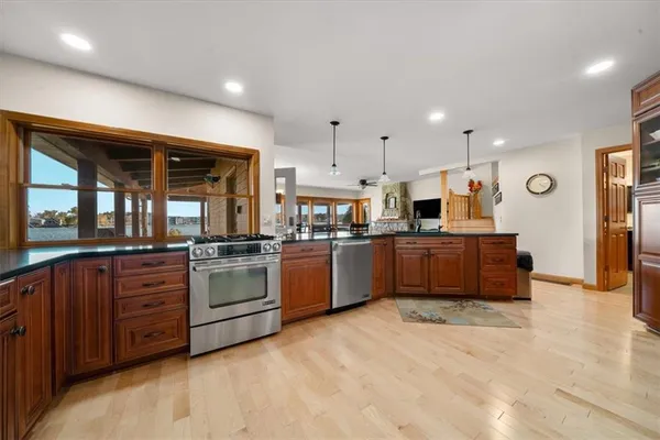 a large kitchen with stainless steel appliances lots of counter top space