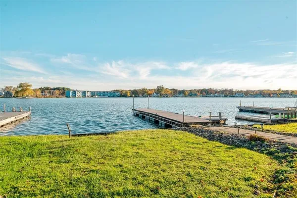 a view of a lake with houses in the back