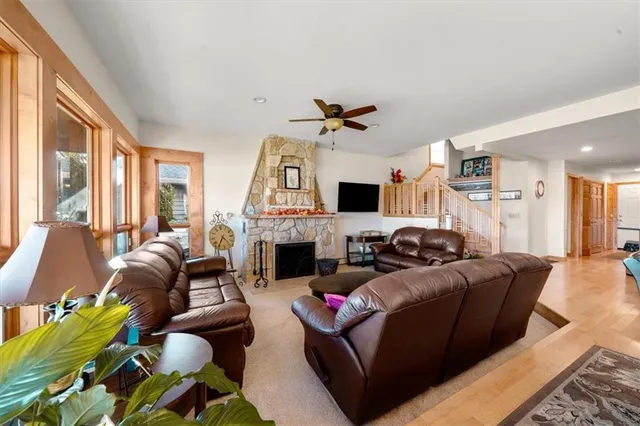 a living room with furniture fireplace and a large window