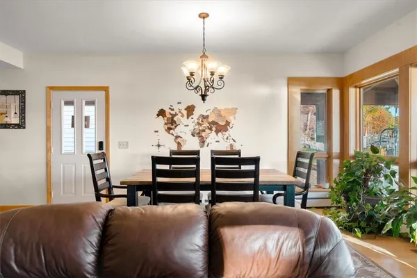 a living room with furniture and a chandelier