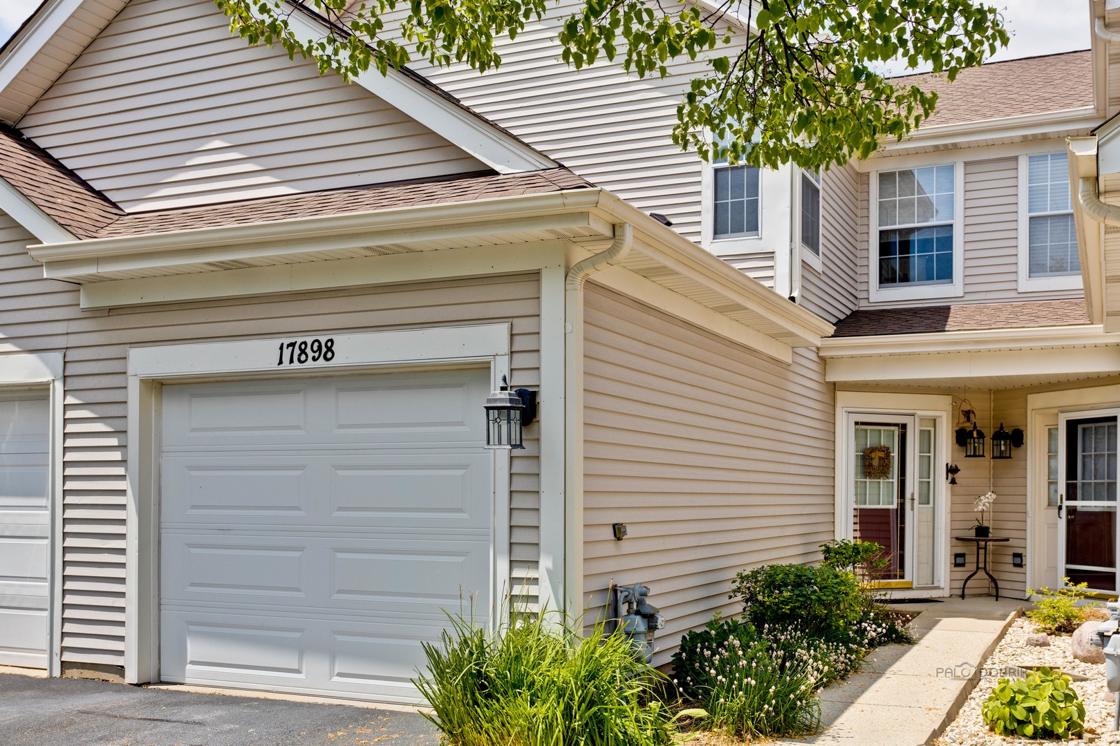 17898 Braewick Road Gurnee, IL 60031 - Photo 1 of 25 a front view of a house with a garden