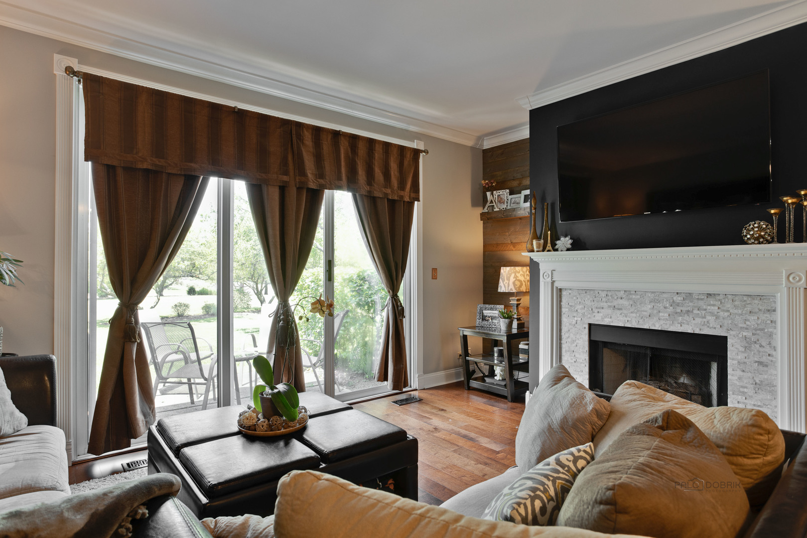 17898 Braewick Road Gurnee, IL 60031 - Photo 12 of 25 a living room with furniture a flat screen tv and a fireplace