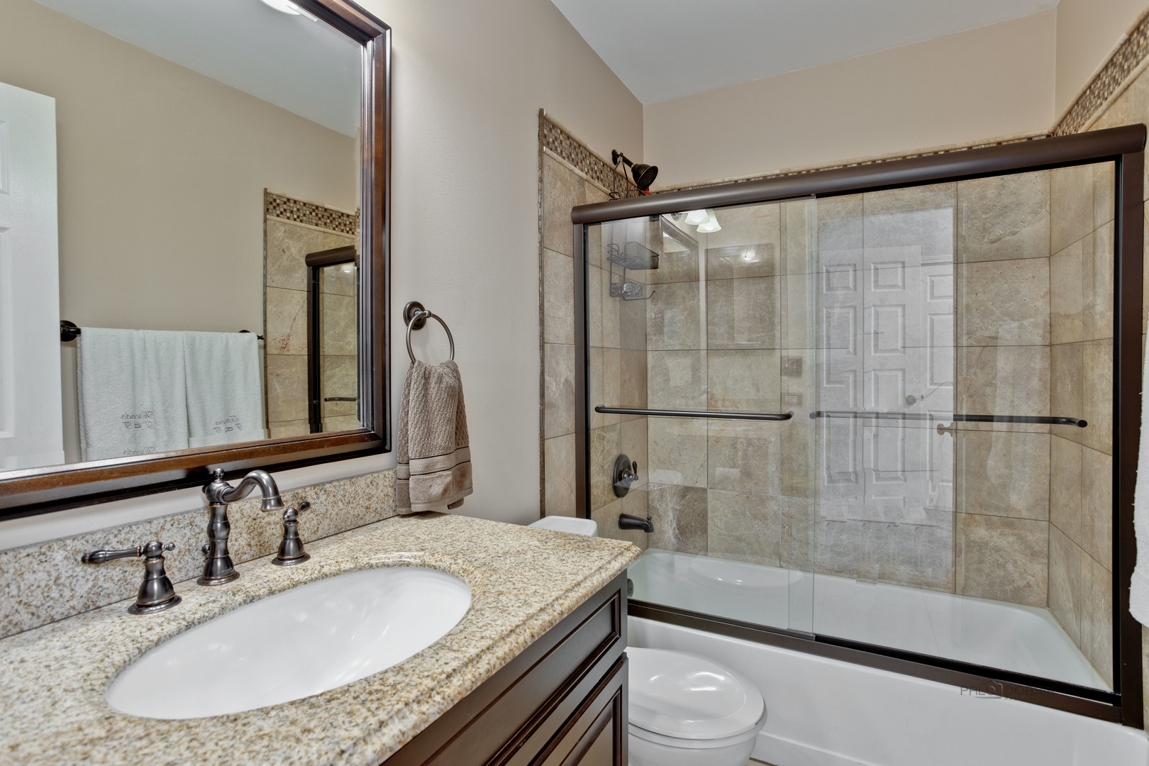 17898 Braewick Road Gurnee, IL 60031 - Photo 17 of 25 a bathroom with a granite countertop sink toilet and shower