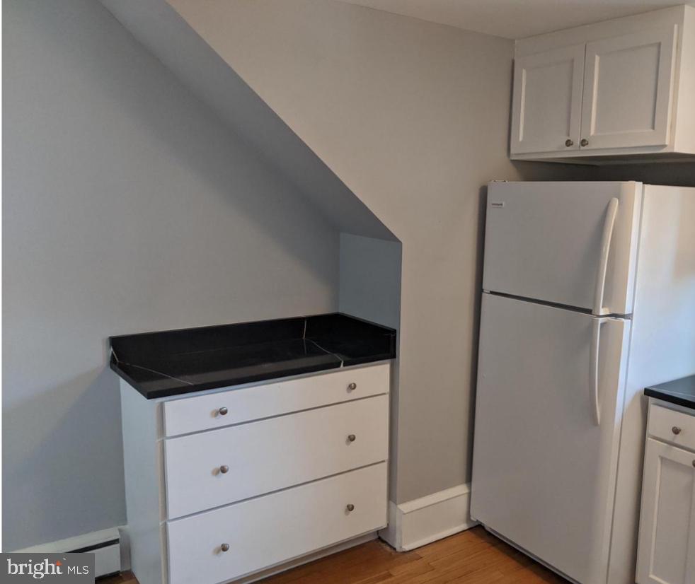205 North Haddon Avenue Haddonfield, NJ 08033 - Photo 5 of 16 a kitchen with white cabinets and white appliances