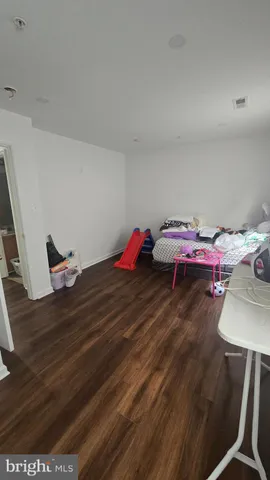 a view of a a dining room with furniture window and wooden floor